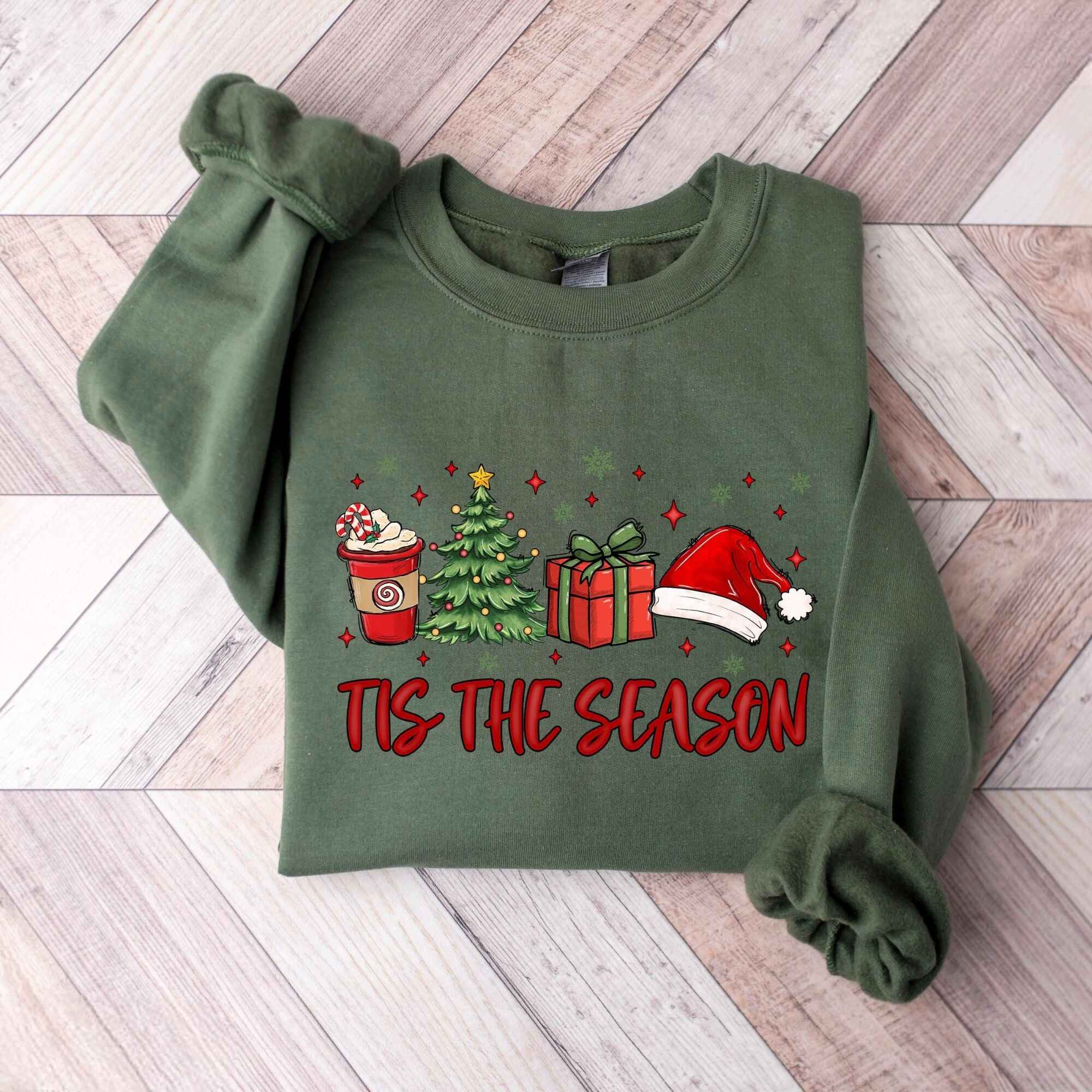 Customizable holiday sweatshirt with "'Tis the Season" design and festive illustrations
