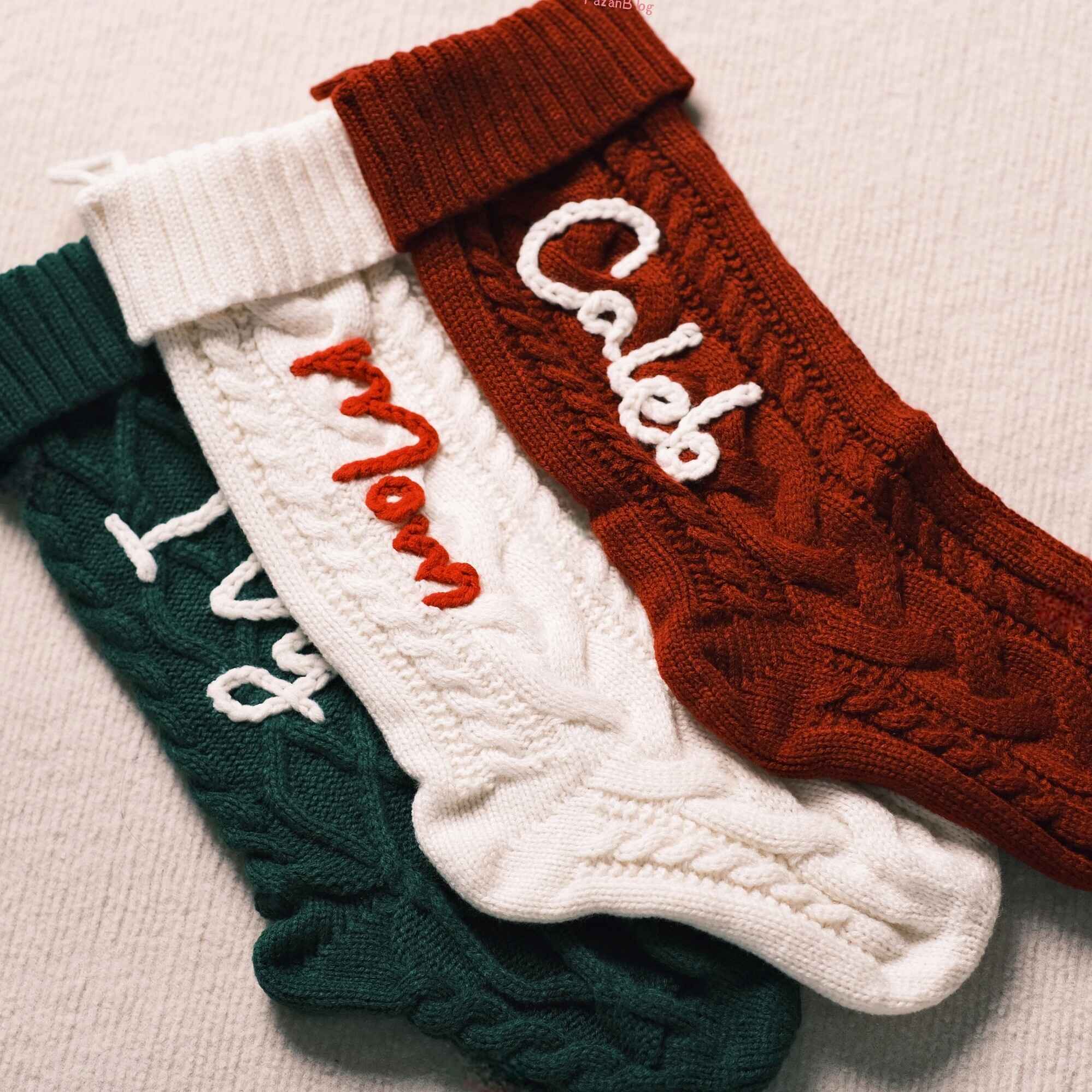 Personalized Christmas stockings with custom names in red, green, and cream
