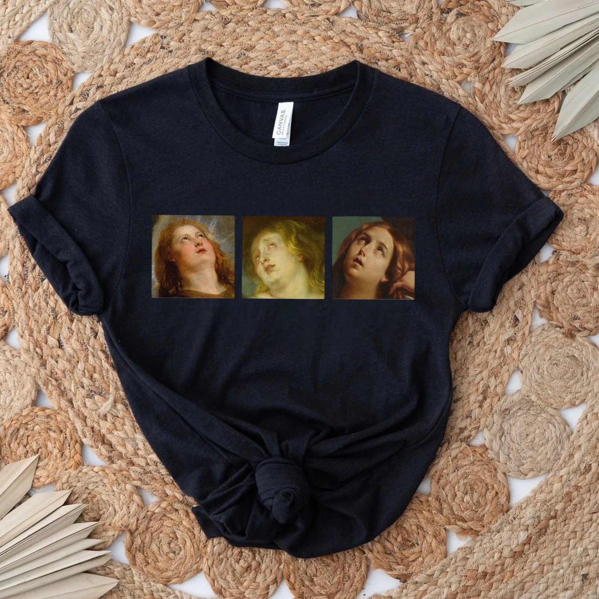 Black t-shirt with classic art faces design on display