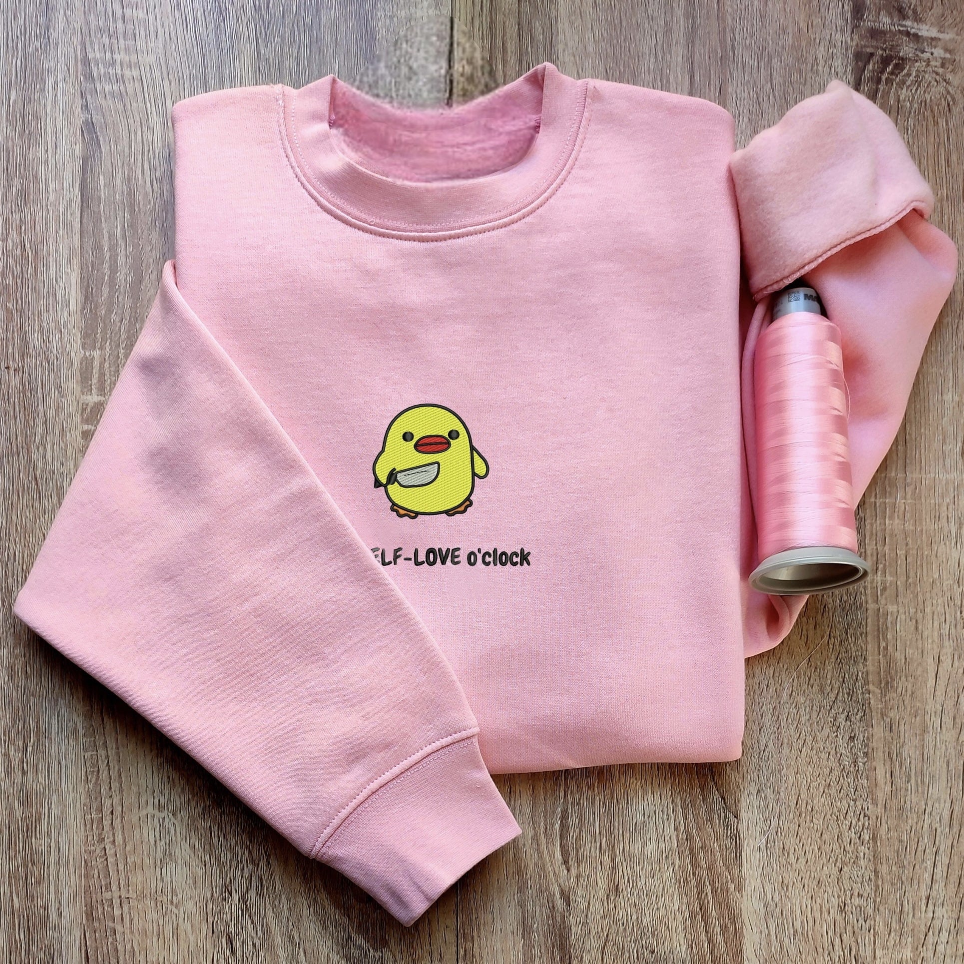 Custom embroidered graphic meme shirts highlighting a playful yellow duck design, great for lovers of funny meme shirts.
