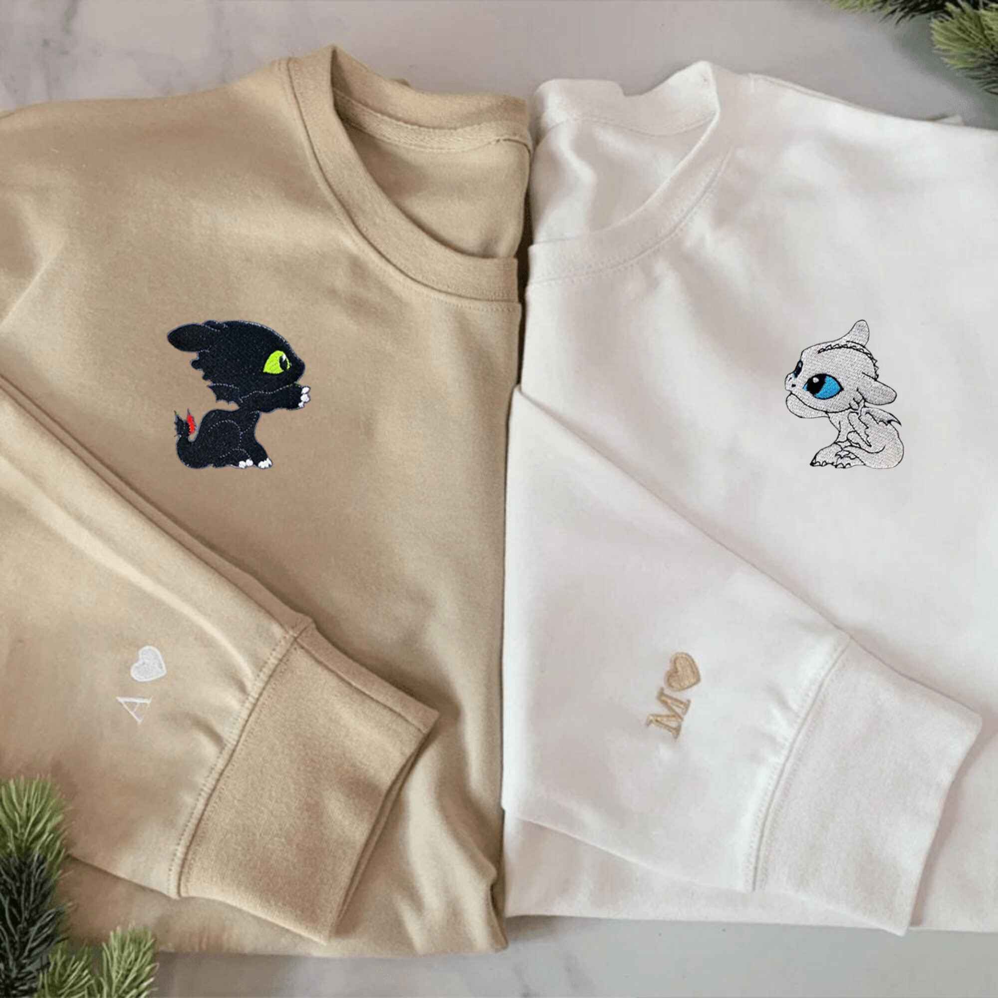 Matching couple hoodies featuring adorable baby dragons, ideal for custom gifts.
