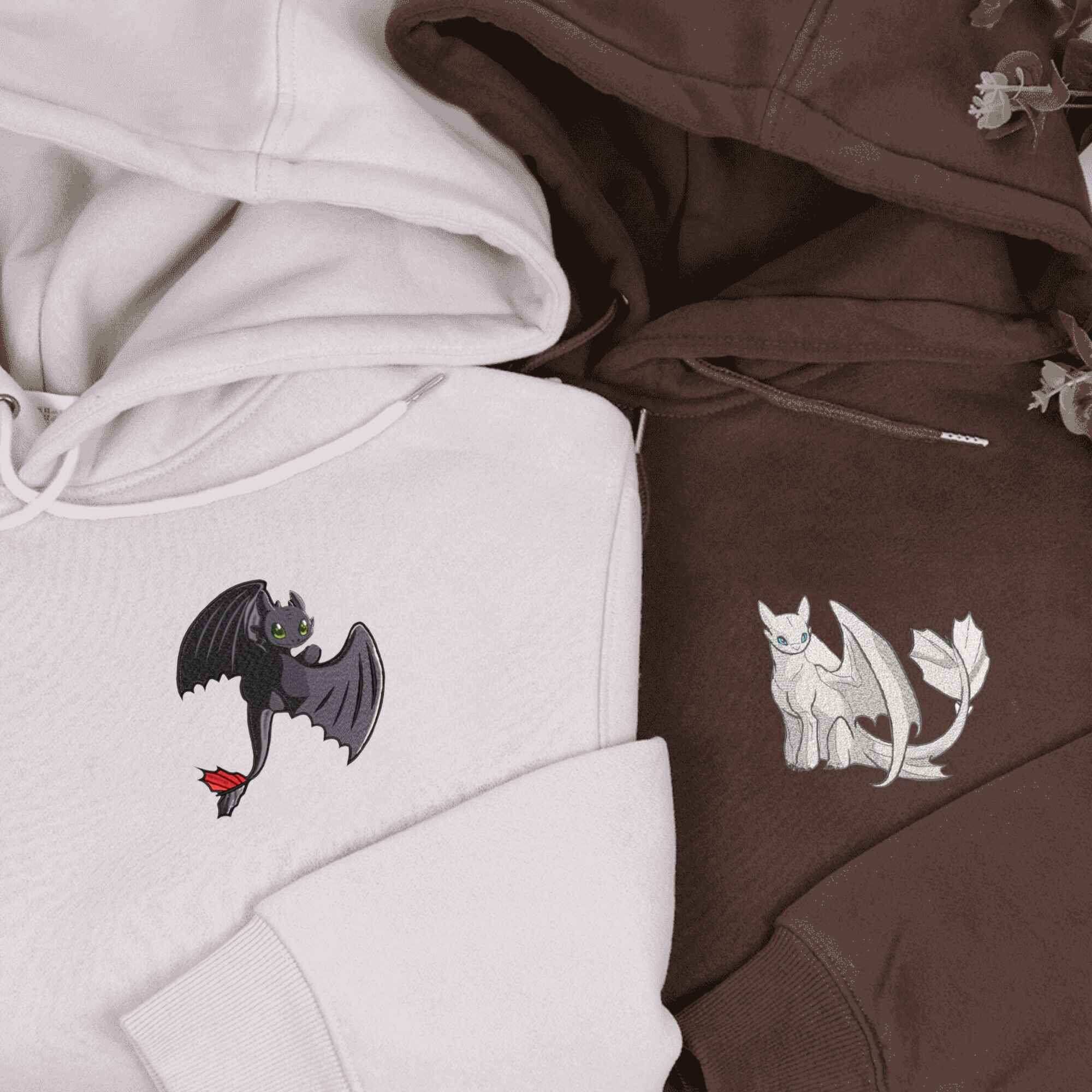 Night Fury & Light Fury couple hoodies featuring embroidered dragons.
