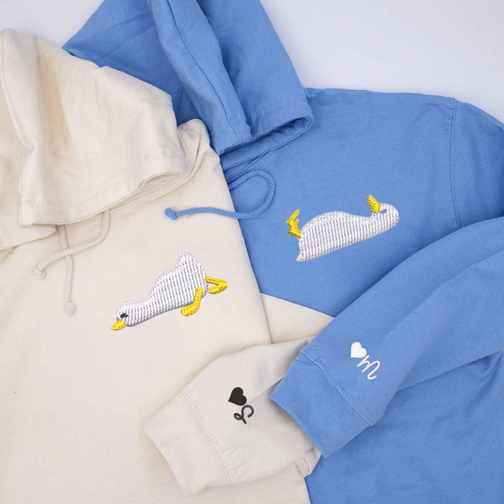 Custom embroidered hoodies featuring cute duck design for couples.
