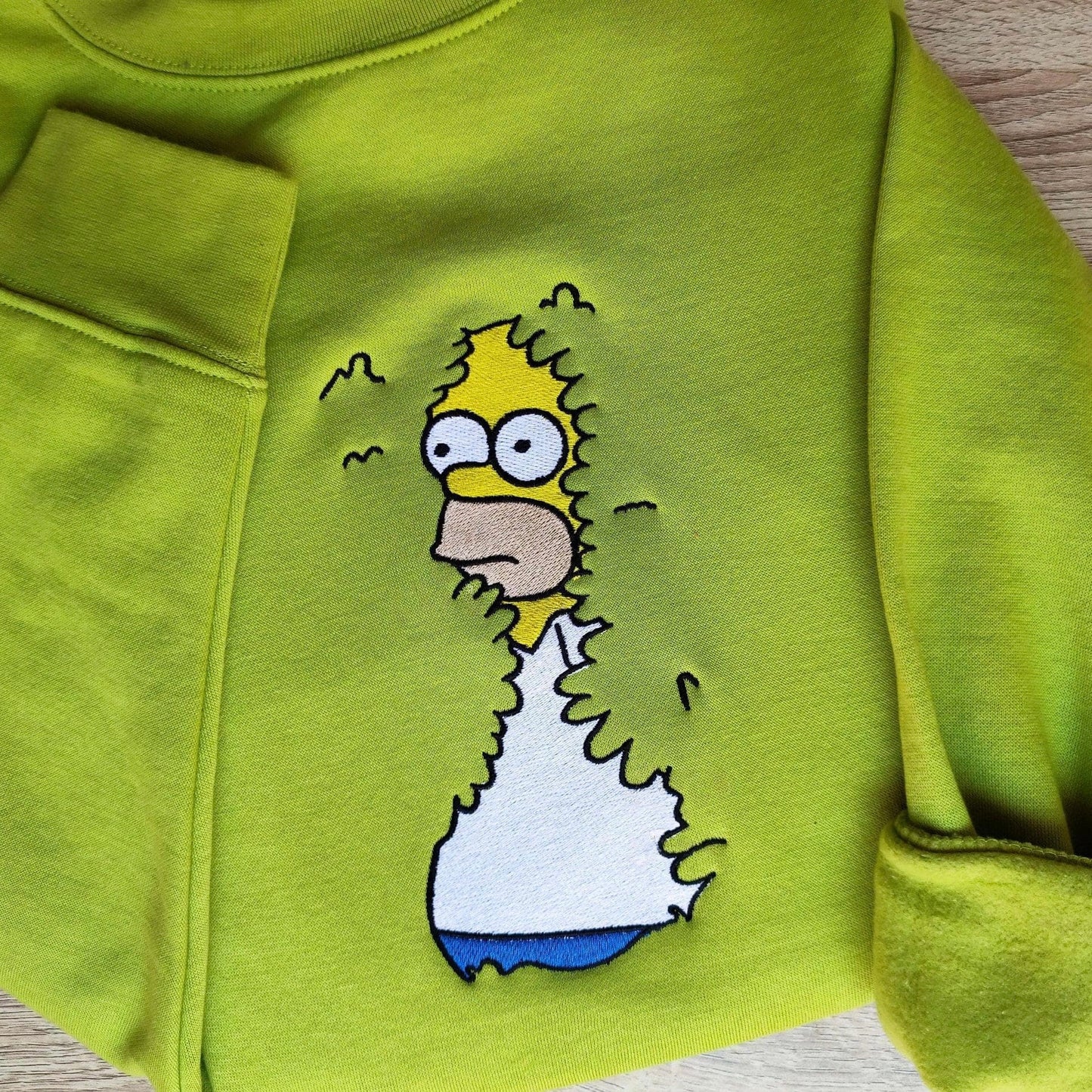 Meme shirt featuring a green hoodie with detailed embroidery of a famous cartoon character, ideal for meme lovers and quirky fashion styles.





