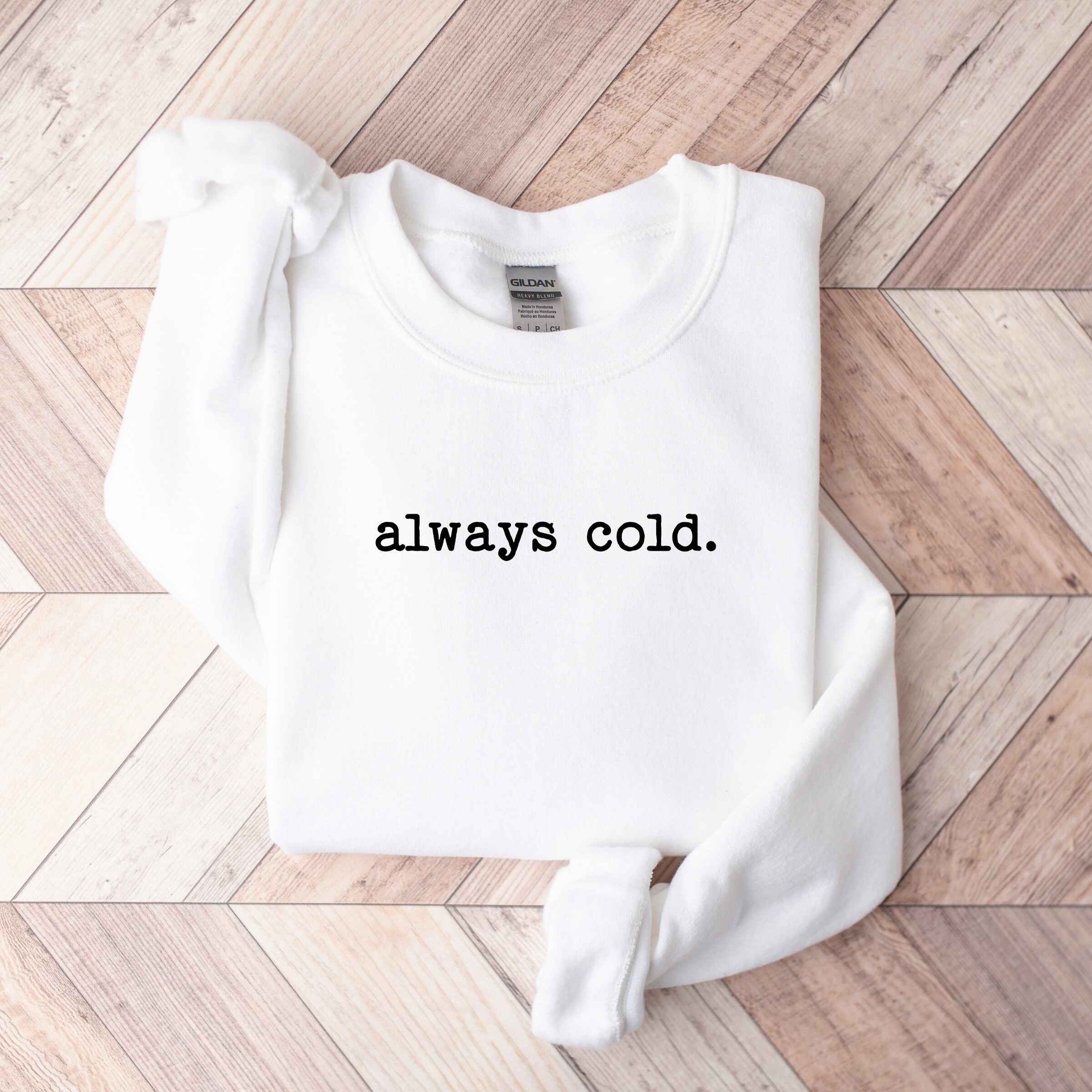 Humorous winter sweatshirt with "Always Cold" text
