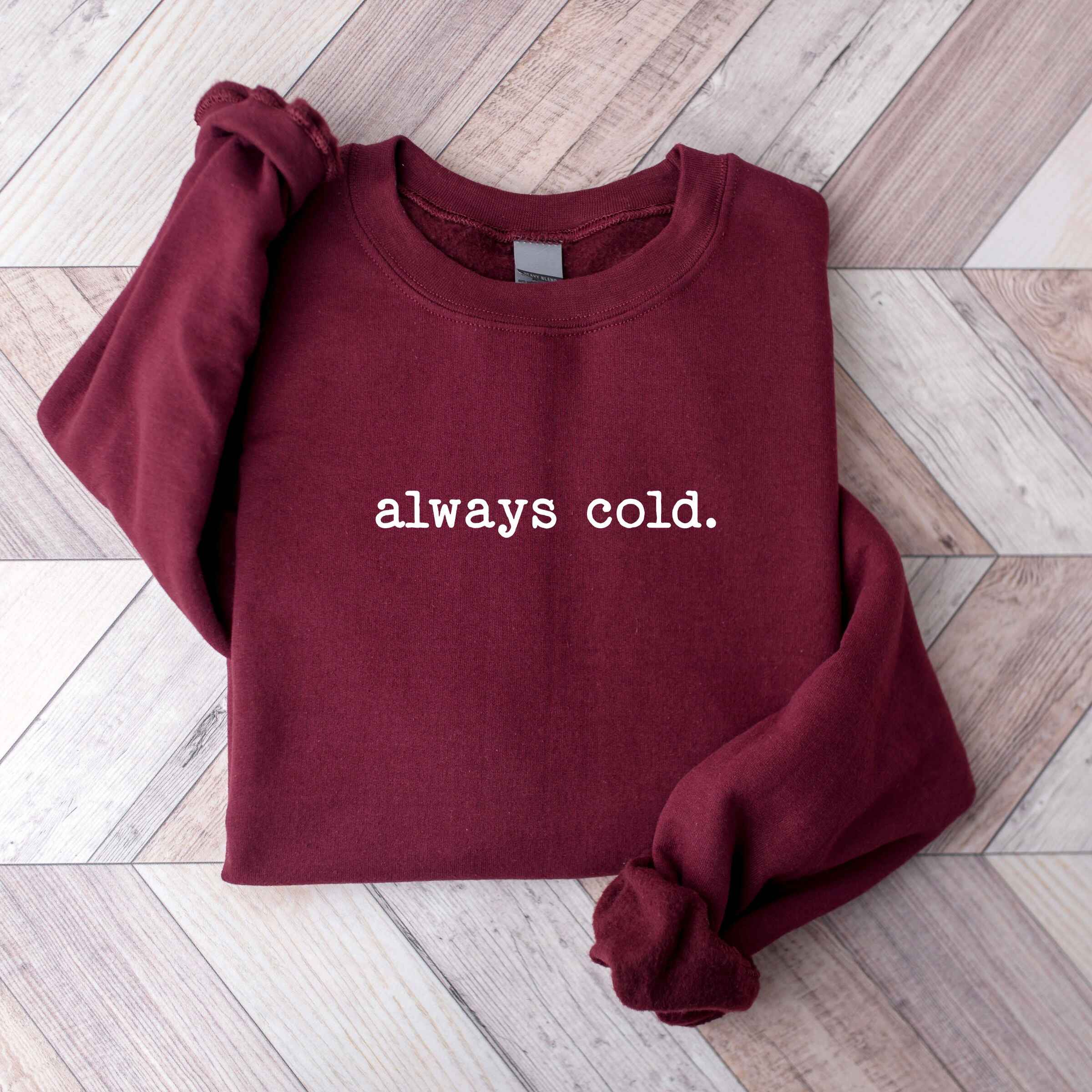 Customizable sweatshirt featuring "Always Cold" design
