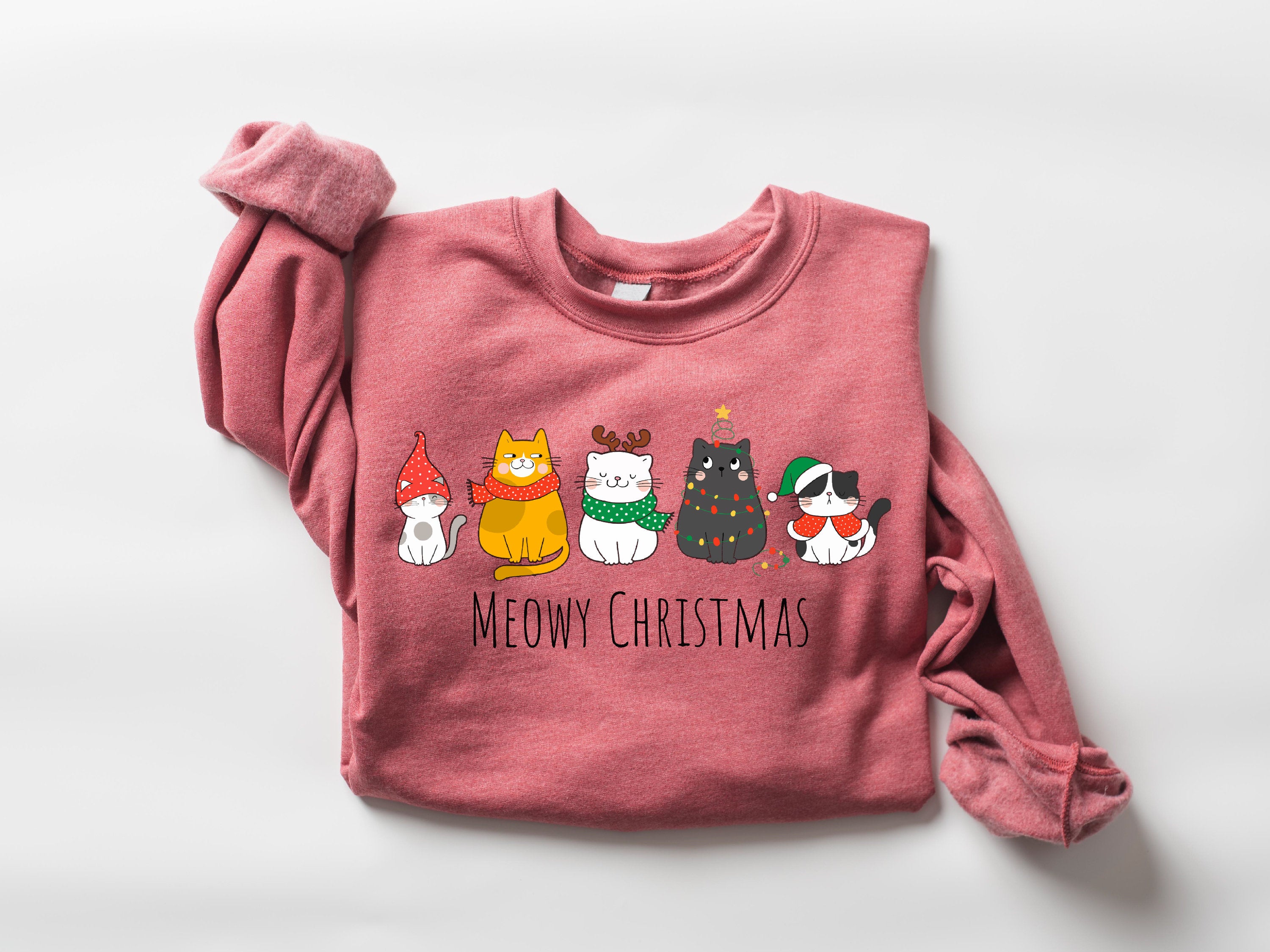 Cozy "Meowy Christmas" sweatshirt with holiday-themed cat illustrations
