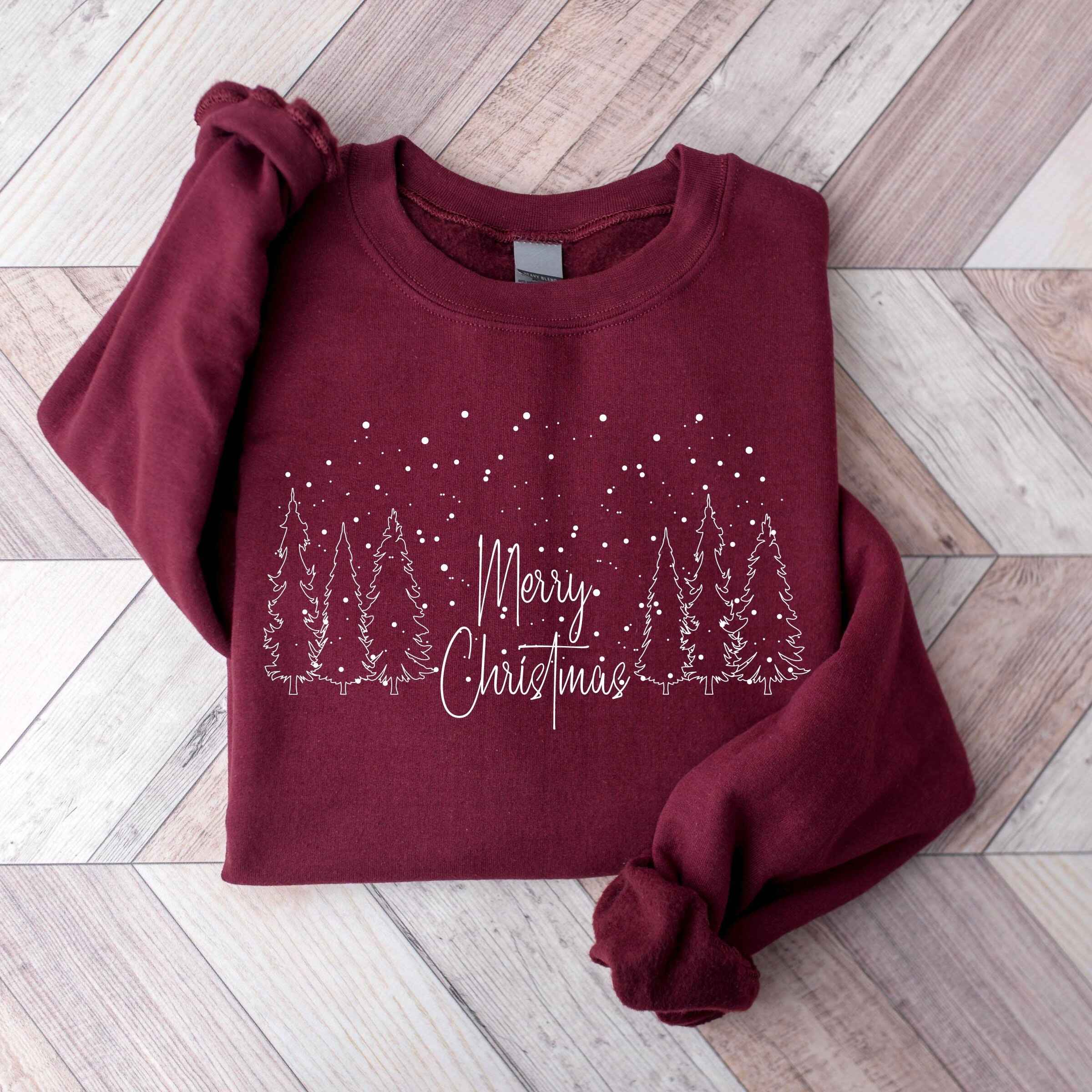 Cozy Christmas sweatshirt featuring festive forest scene
