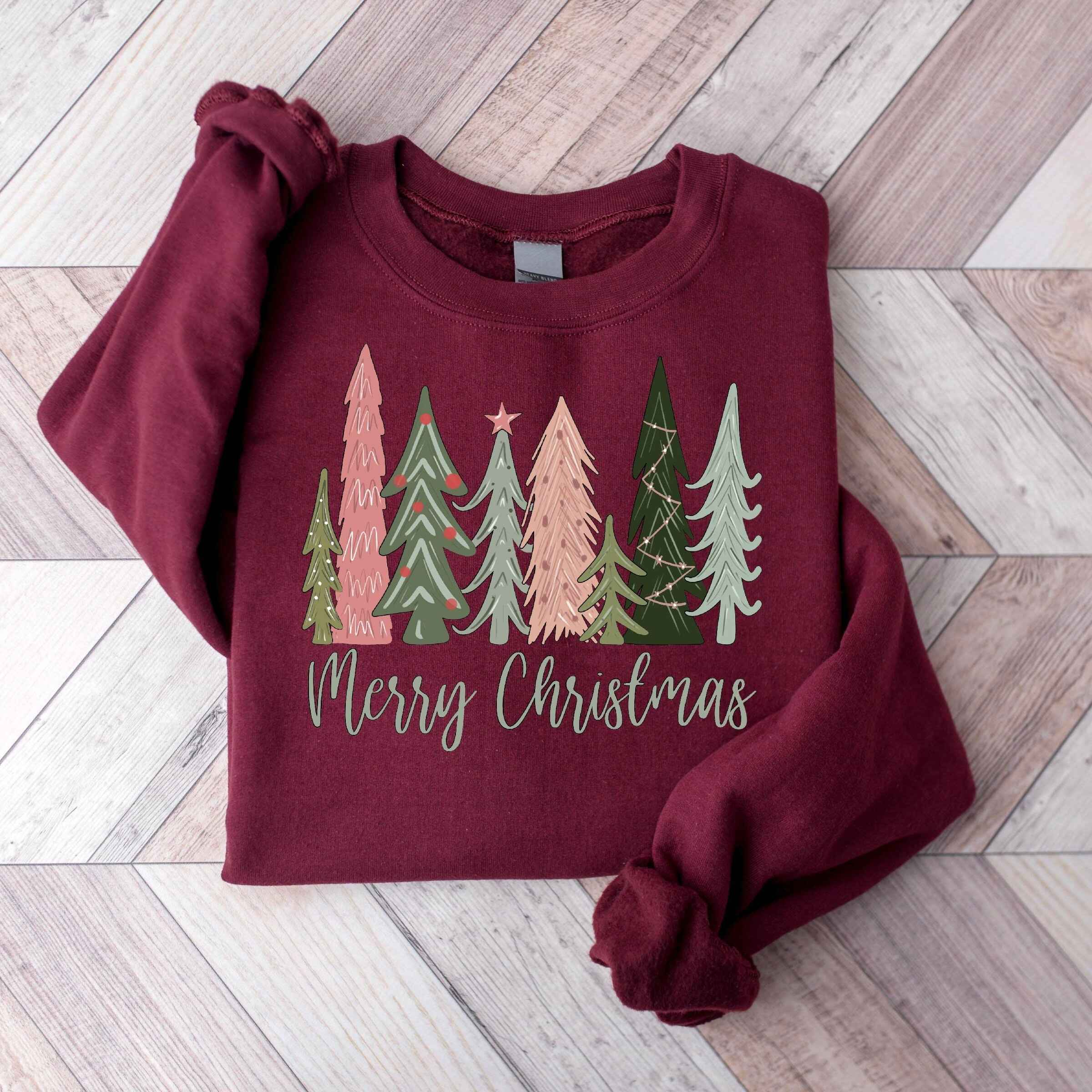 Green "Merry Christmas" sweatshirt with pastel holiday tree design
