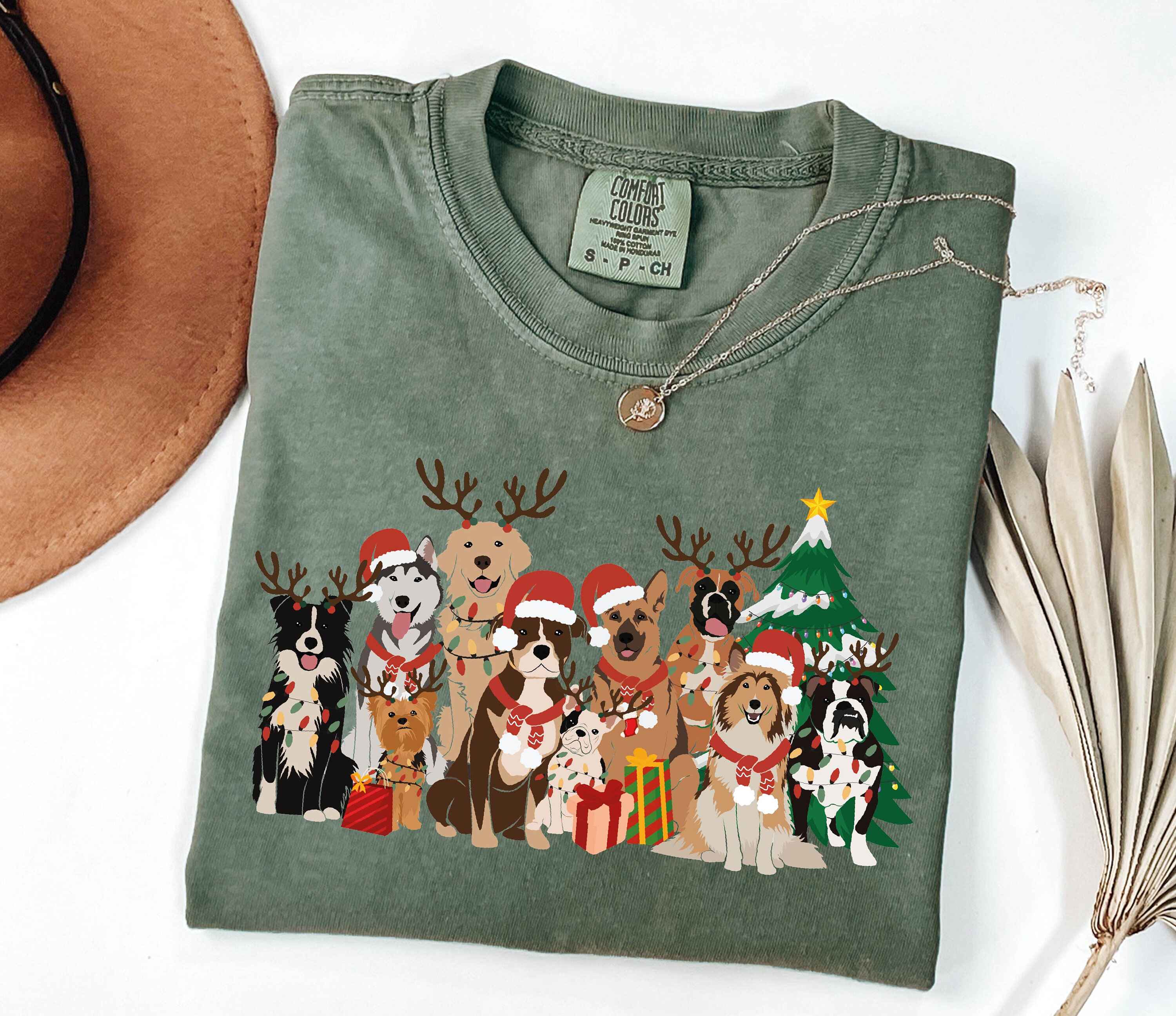 Holiday t-shirt featuring dogs with Santa hats and reindeer antlers
