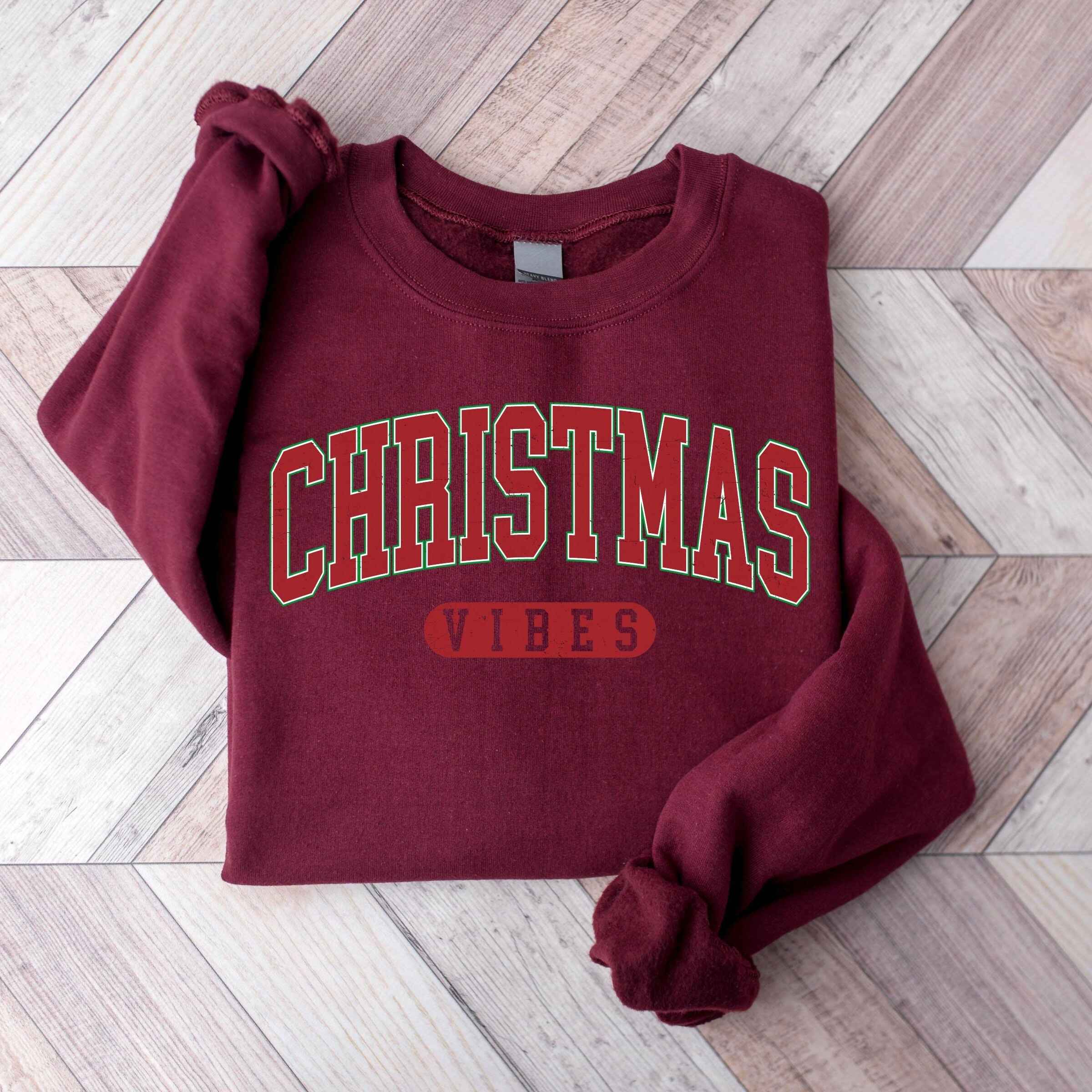 Cozy Christmas sweatshirt in customizable colors with "Christmas Vibes" text
