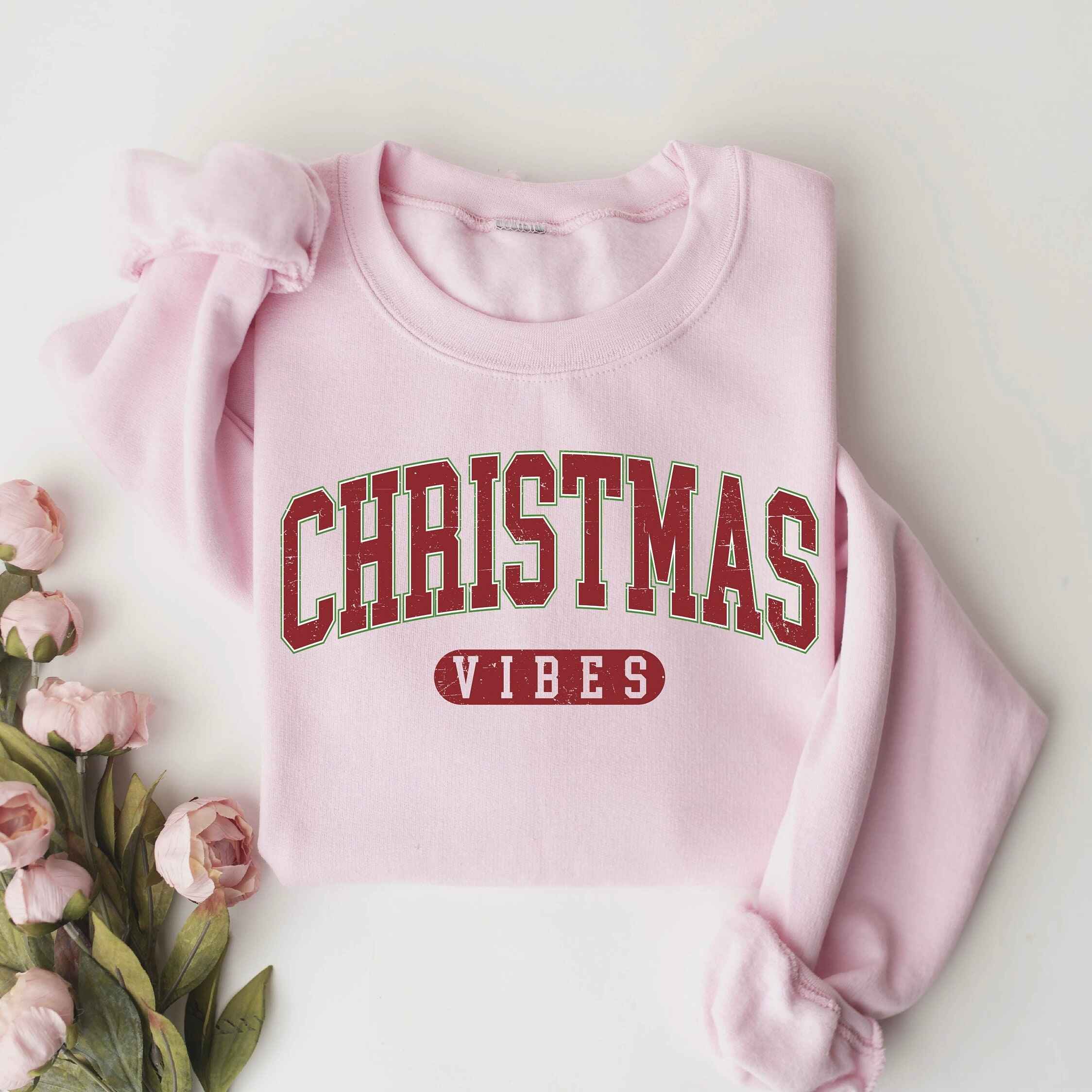 "Christmas Vibes" sweatshirt with festive red and green design
