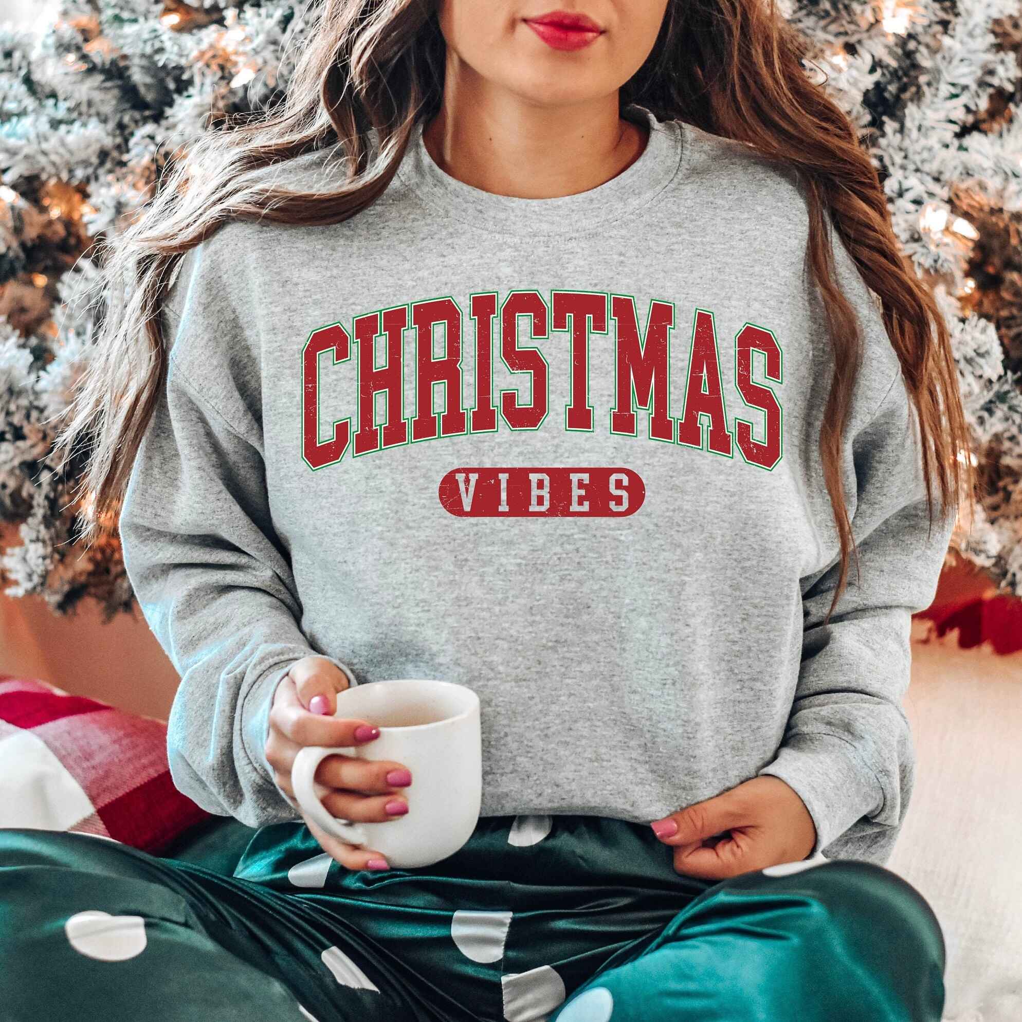 "Christmas Vibes" sweatshirt with festive red and green design
