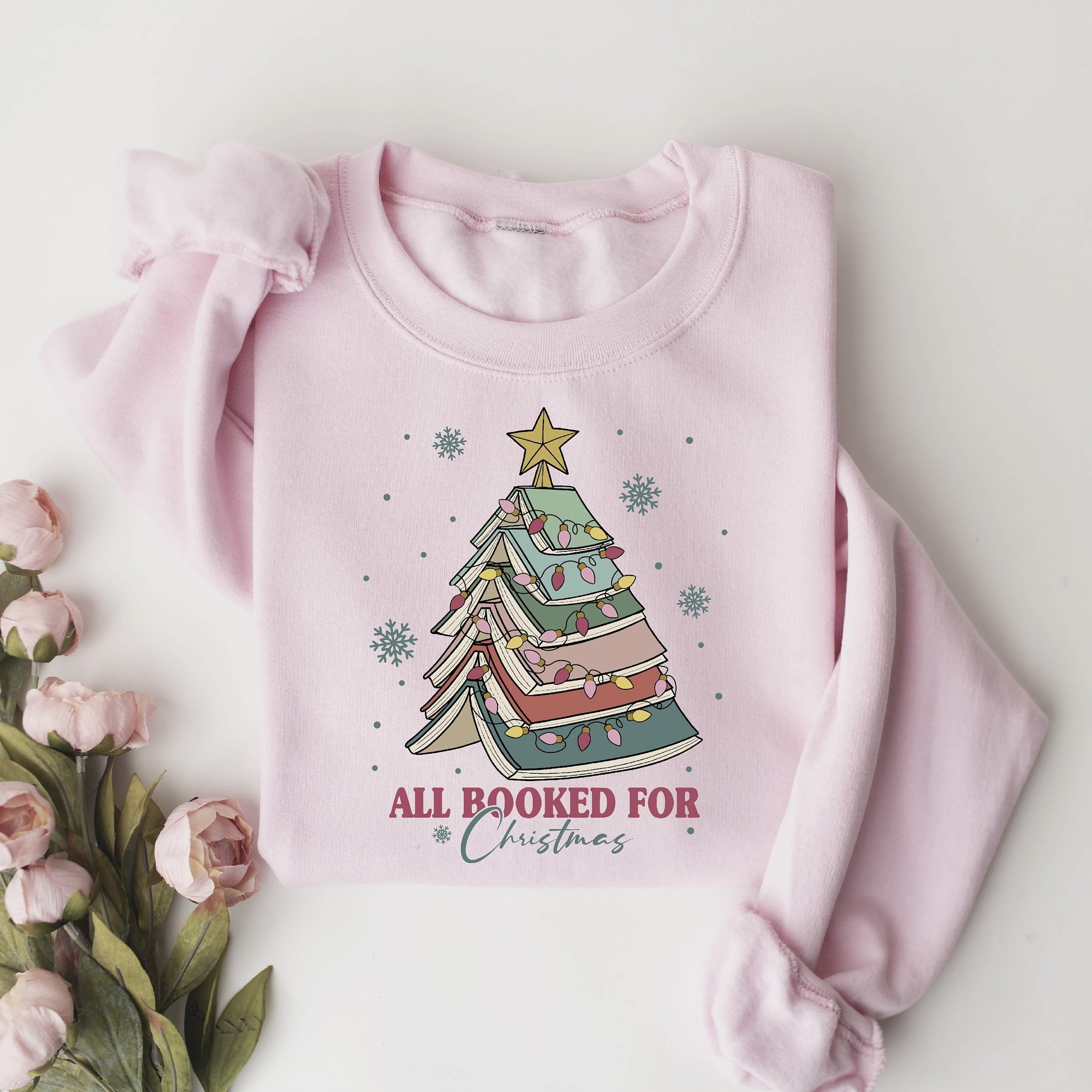 Cozy holiday sweatshirt featuring a book stack Christmas tree
