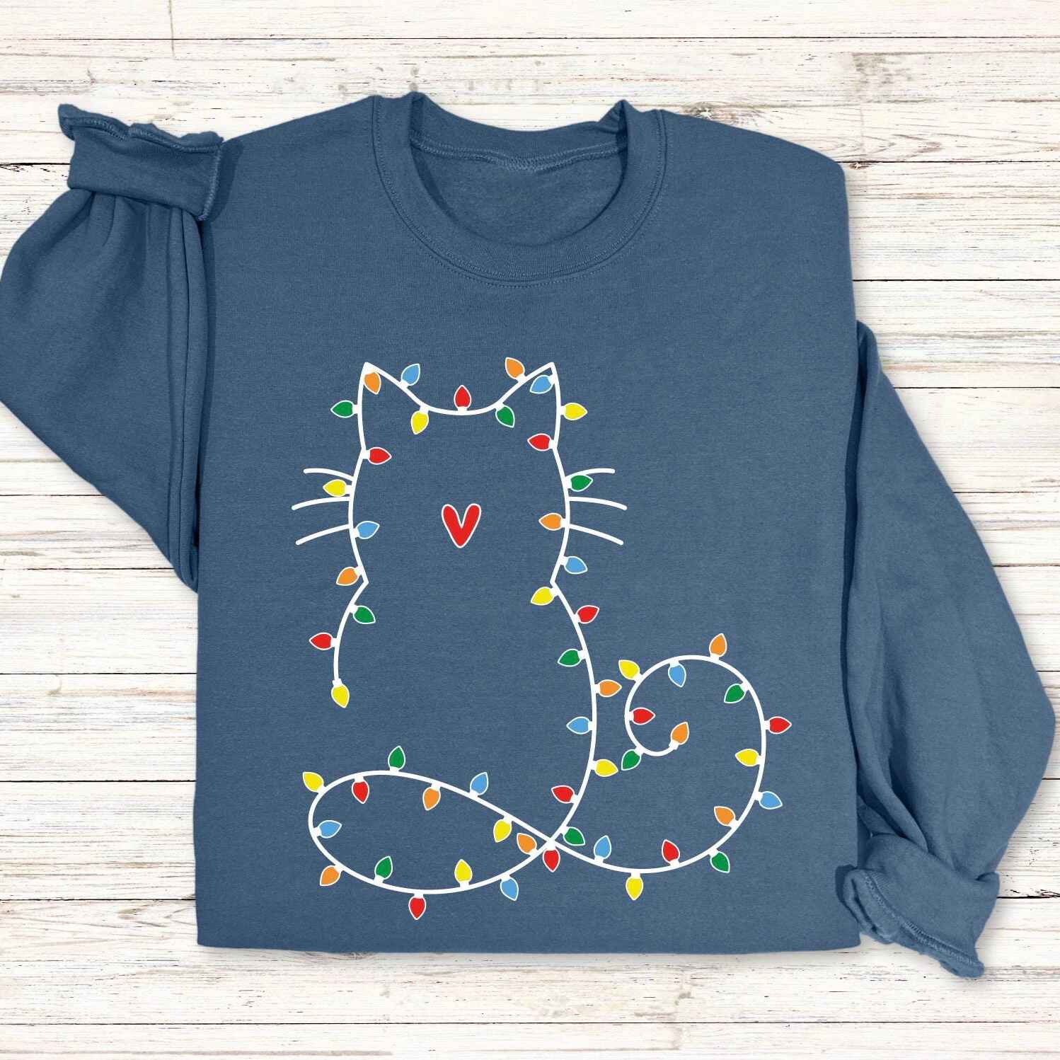 Cozy Christmas cat sweatshirt in pink with holiday light outline
