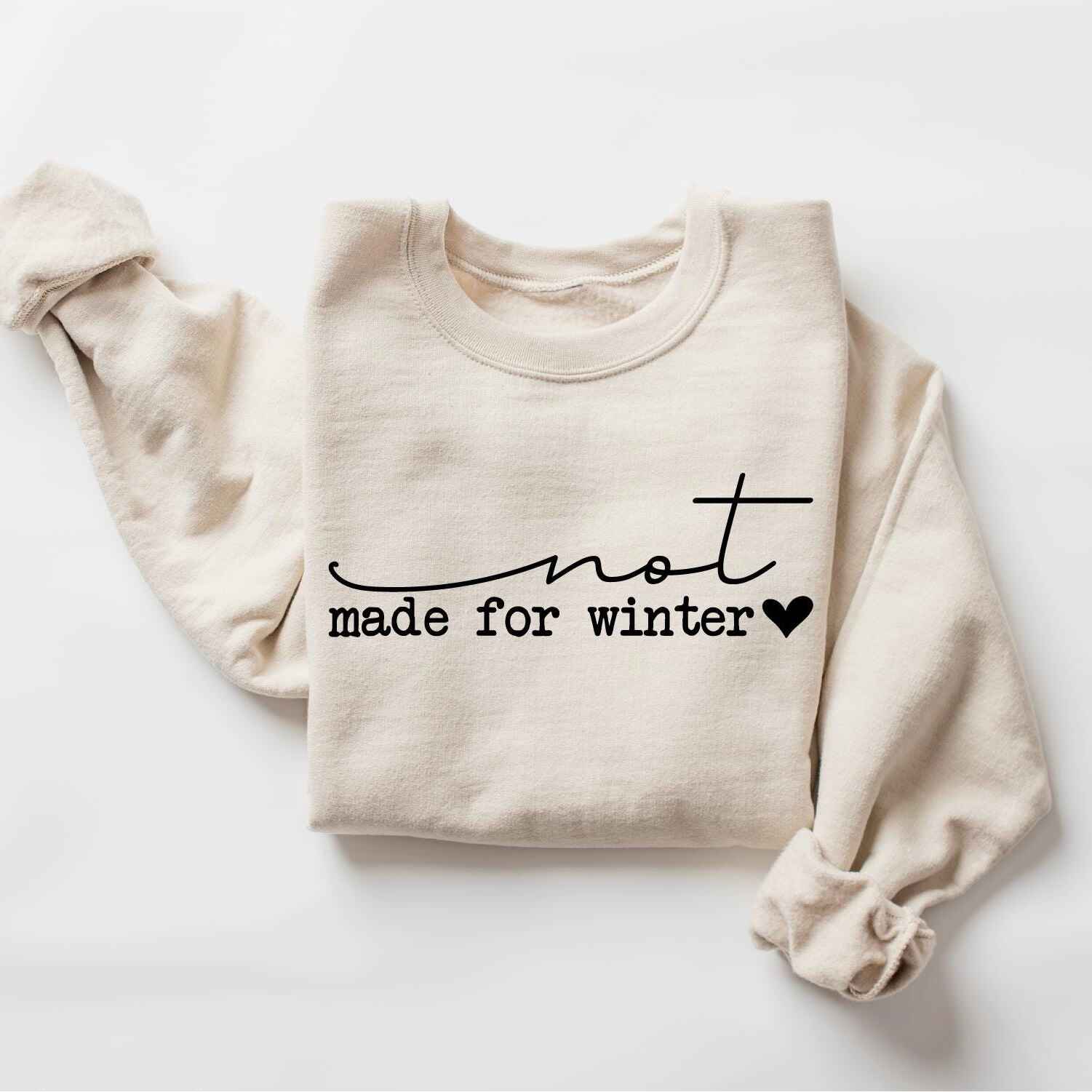 Fun seasonal sweatshirt with "Not Made for Winter" text
