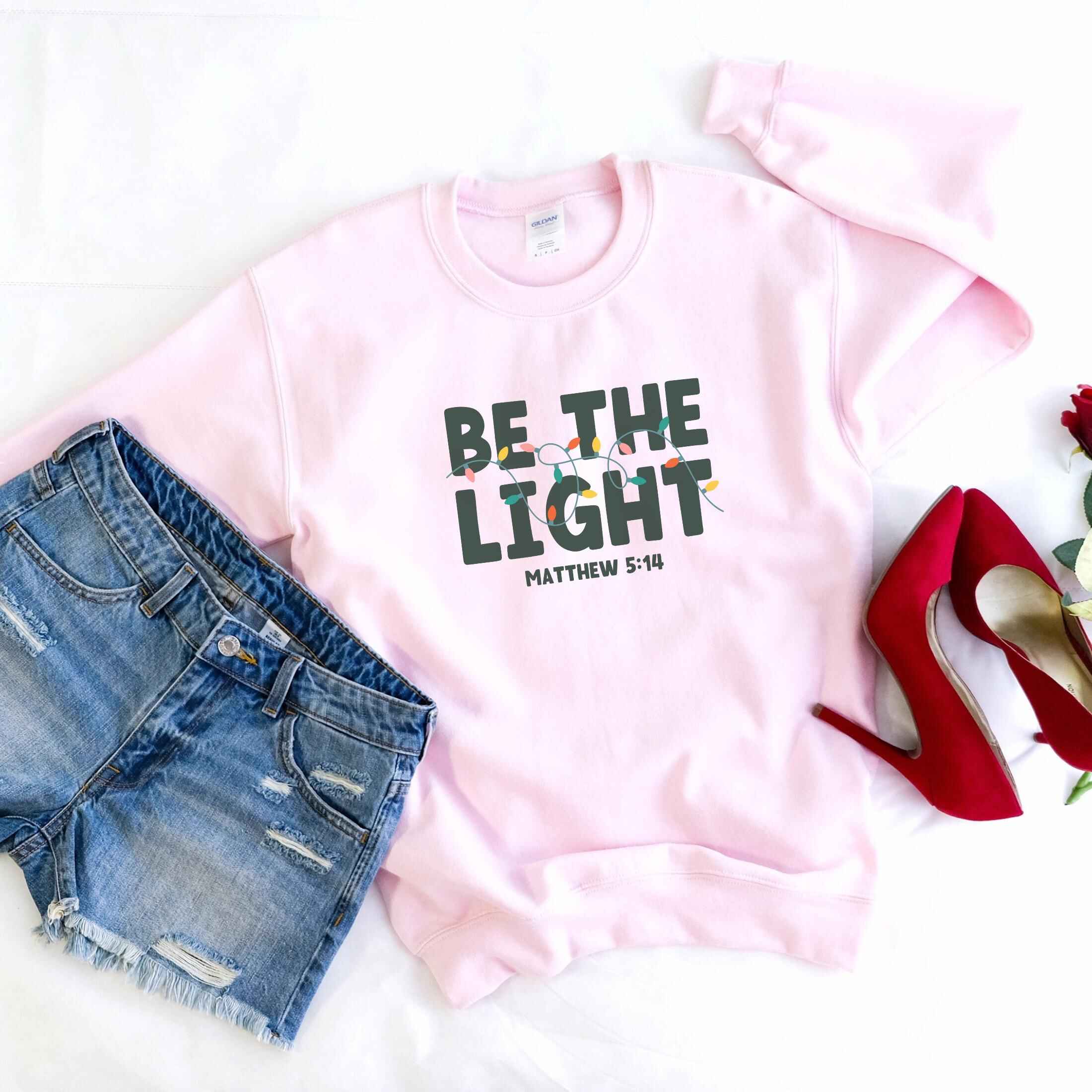 Cozy sweatshirt featuring Matthew 5:14 and holiday lights, various color options
