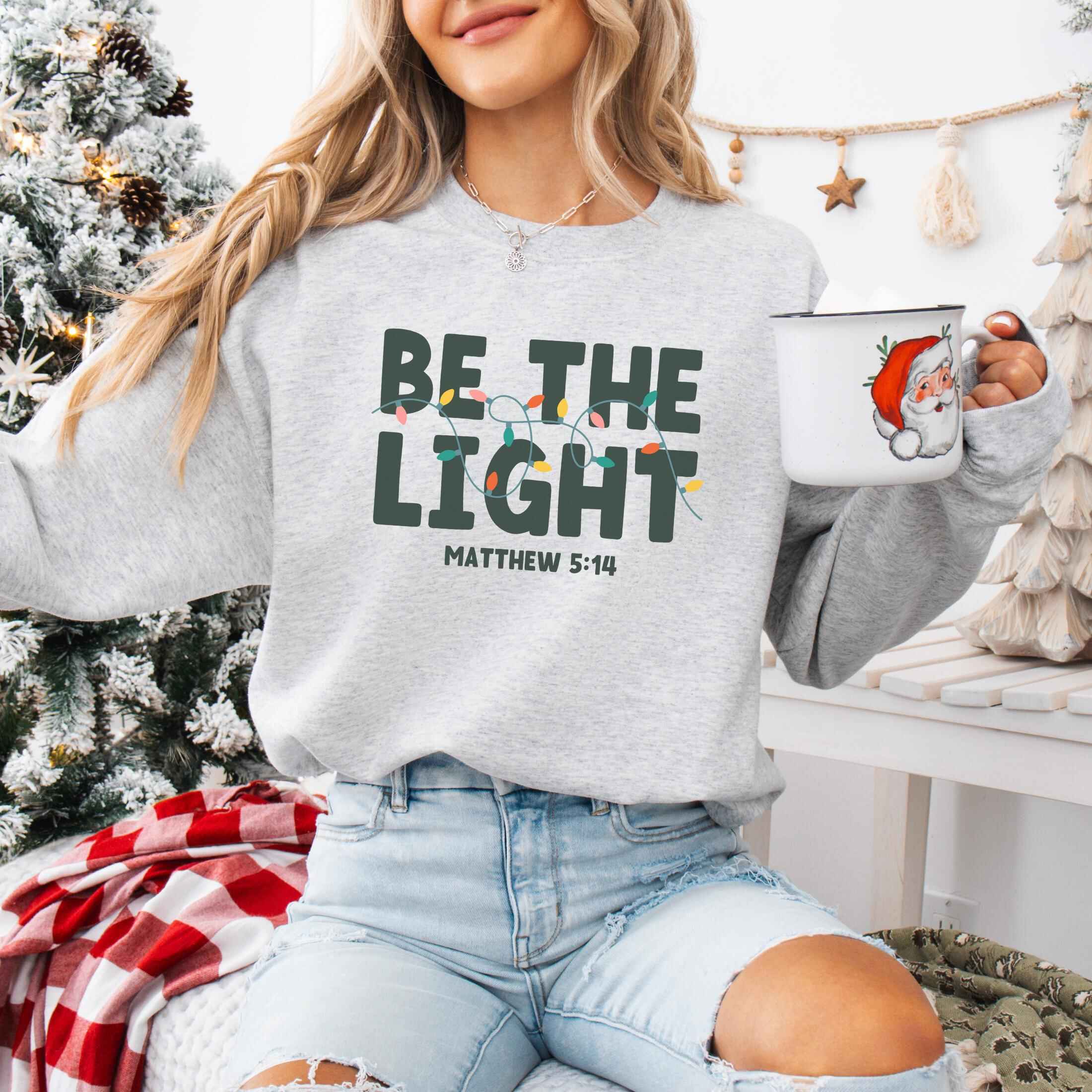 Cozy sweatshirt featuring Matthew 5:14 and holiday lights, various color options
