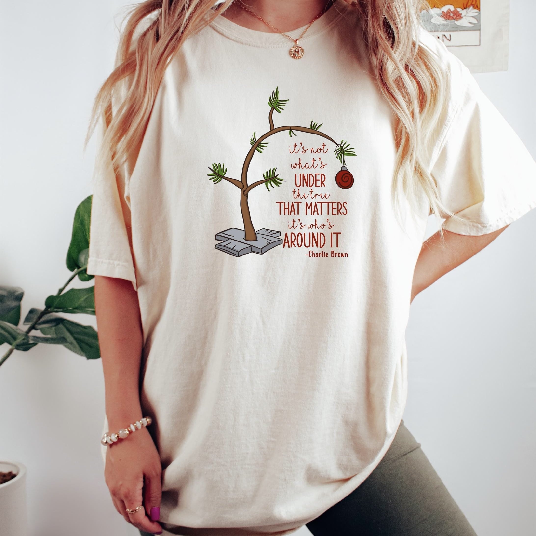 Cozy Christmas sweater featuring a simple tree graphic and festive quote, perfect for holiday gatherings.
