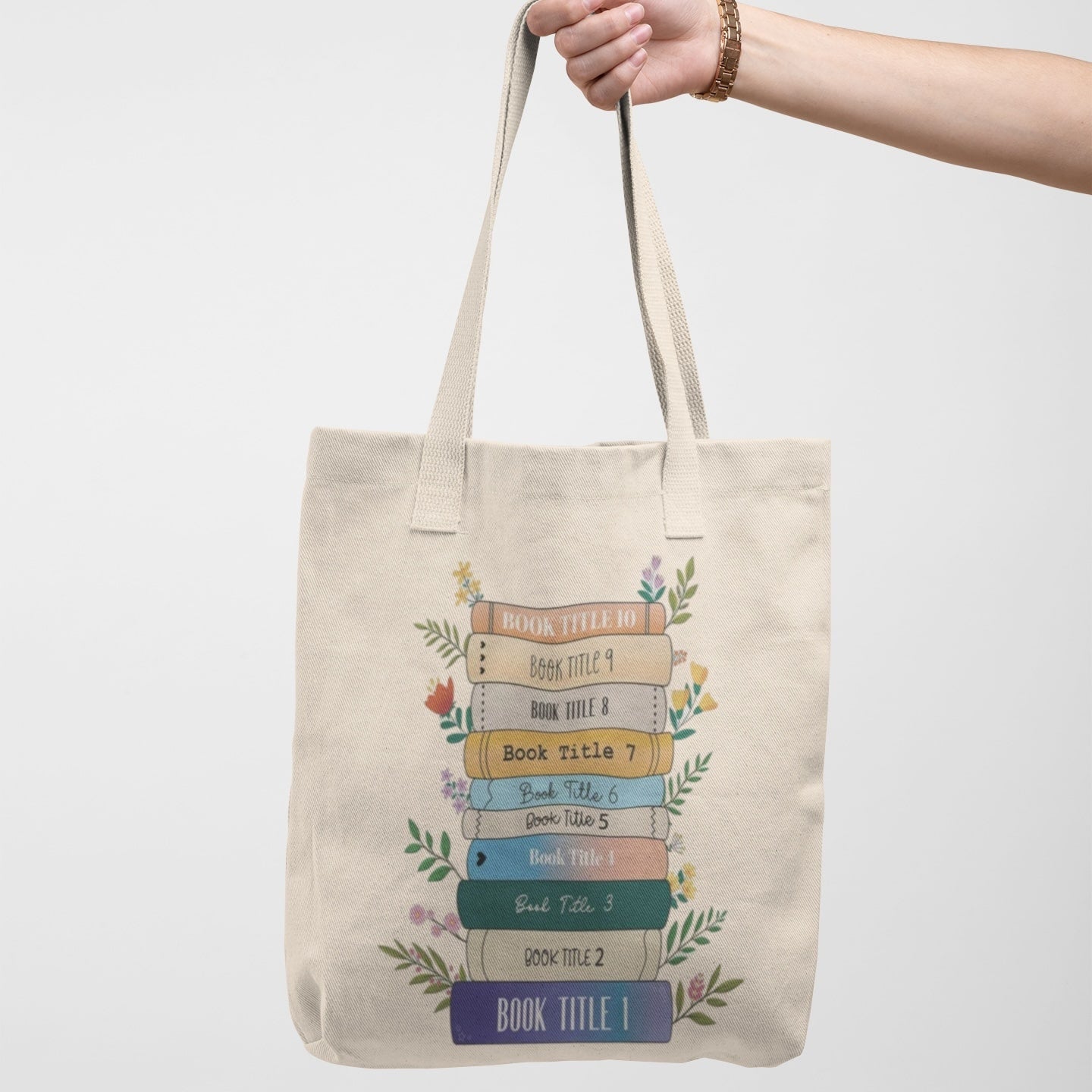 Personalized book stack tote bag with floral accents